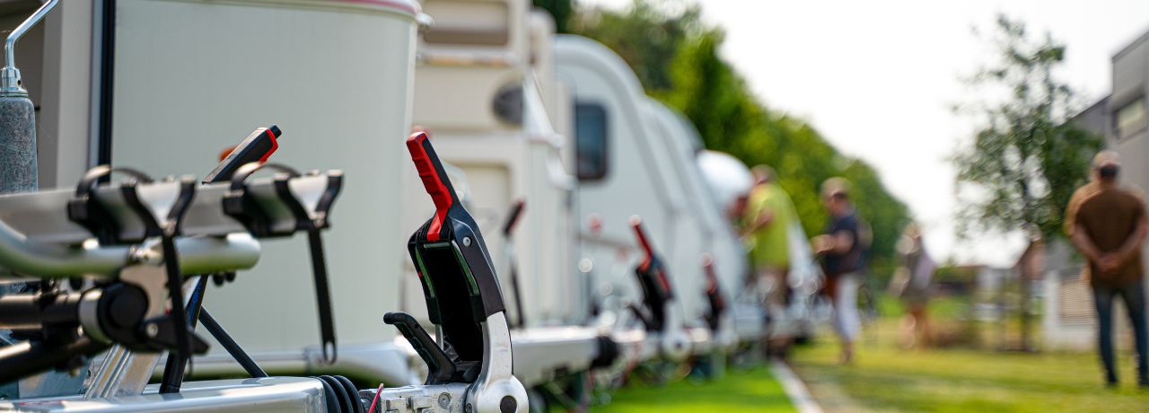 Travel trailers and RVs on display at an outdoor RV show.